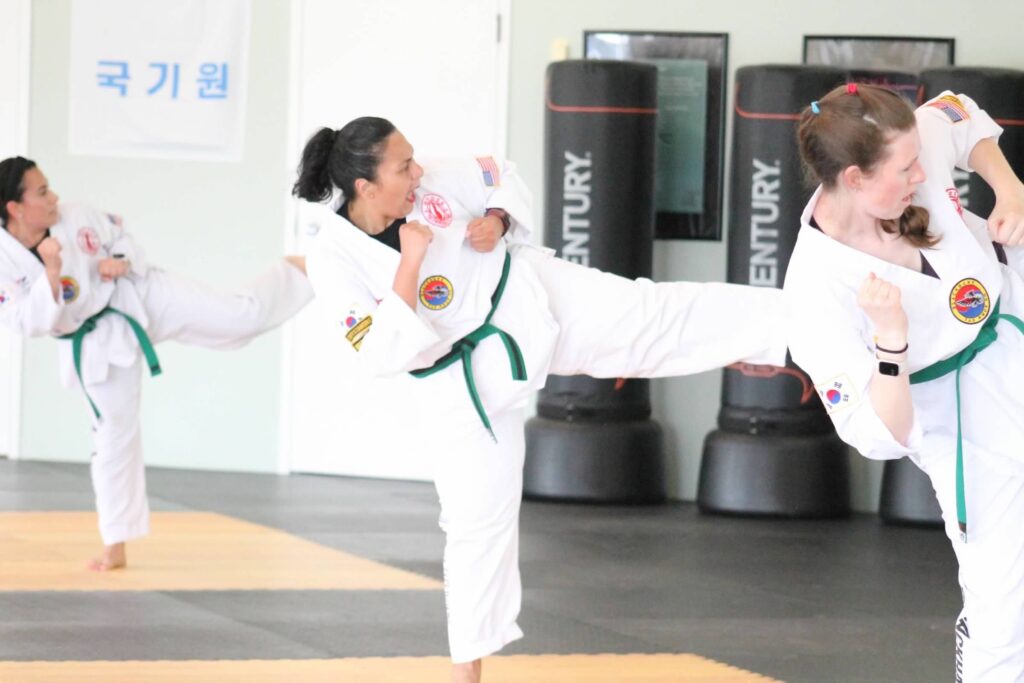 Adults practicing traditional Taekwondo techniques at Blackhawk TaeKwonDo in Carpentersville