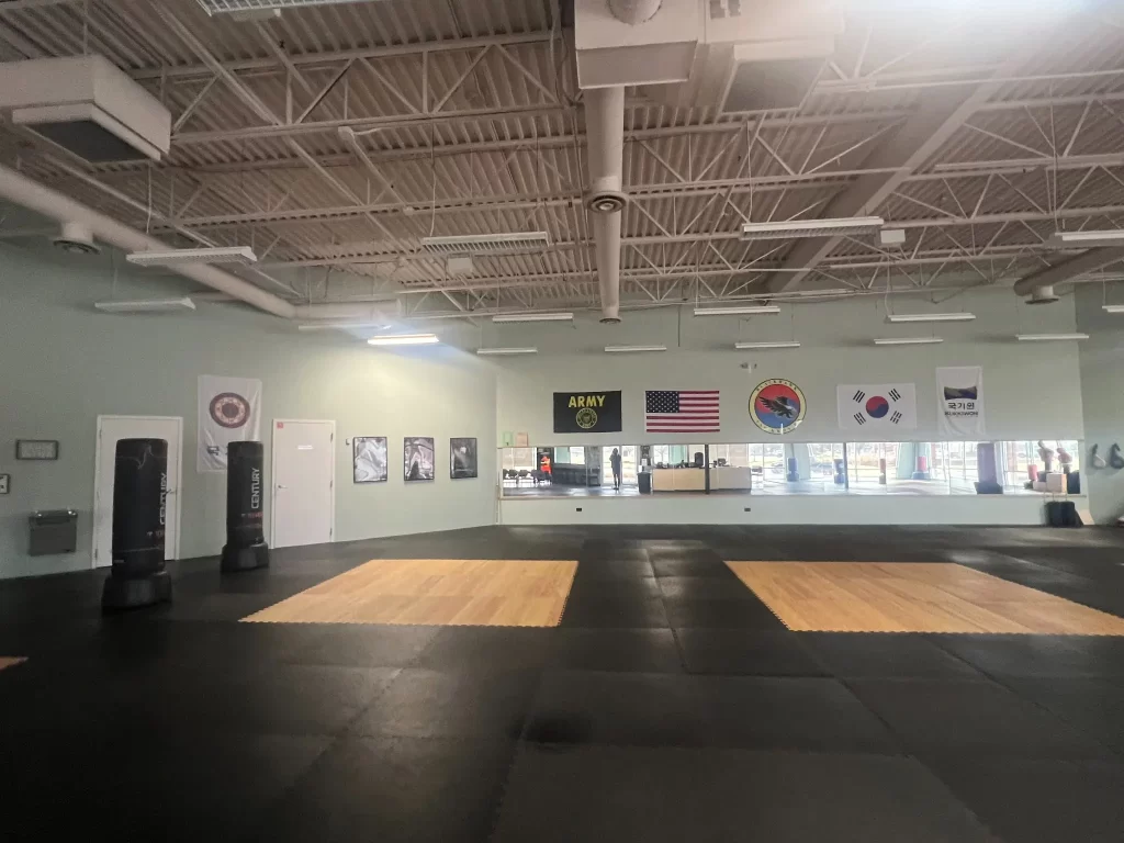 Matted training floor with mirrors and freestanding bags at Blackhawk TaeKwonDo in Carpentersville.